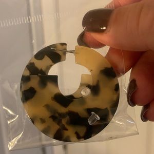 Pair of tortoise color statement earrings with clear backs, new in bag.